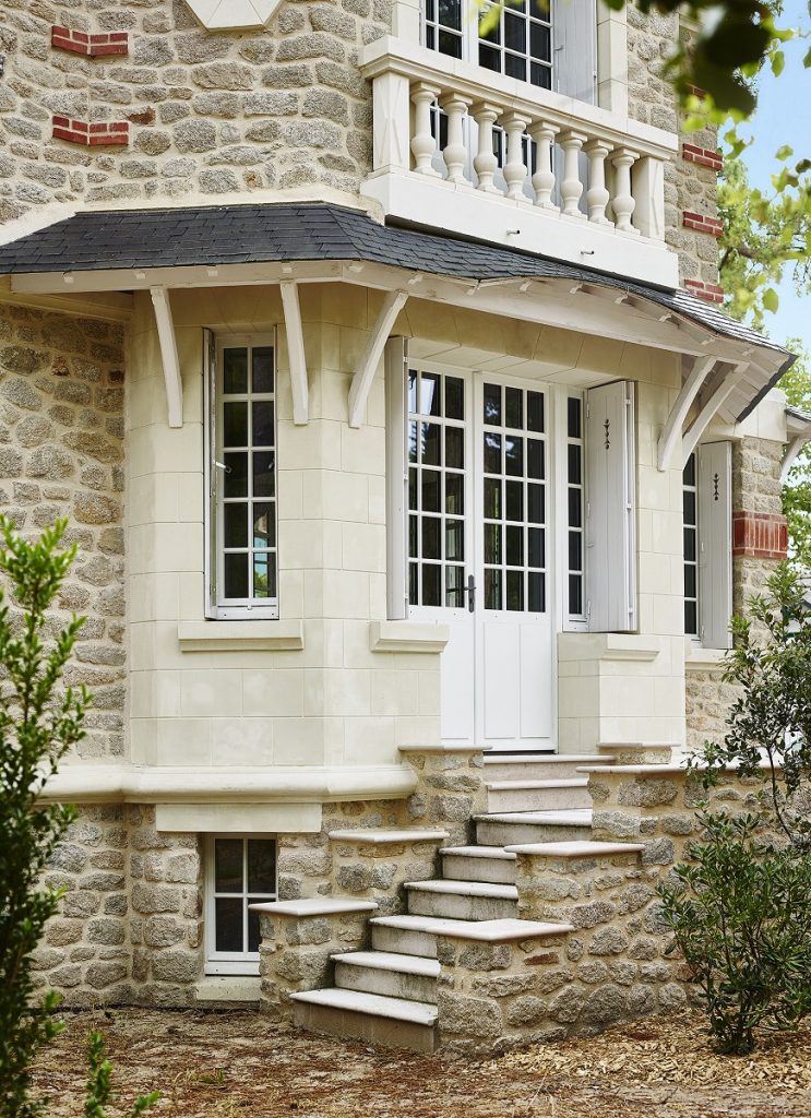 Vue extérieure d'un bâtiment ancien avec des menuiseries extérieures sur mesure en bois gamme prestige